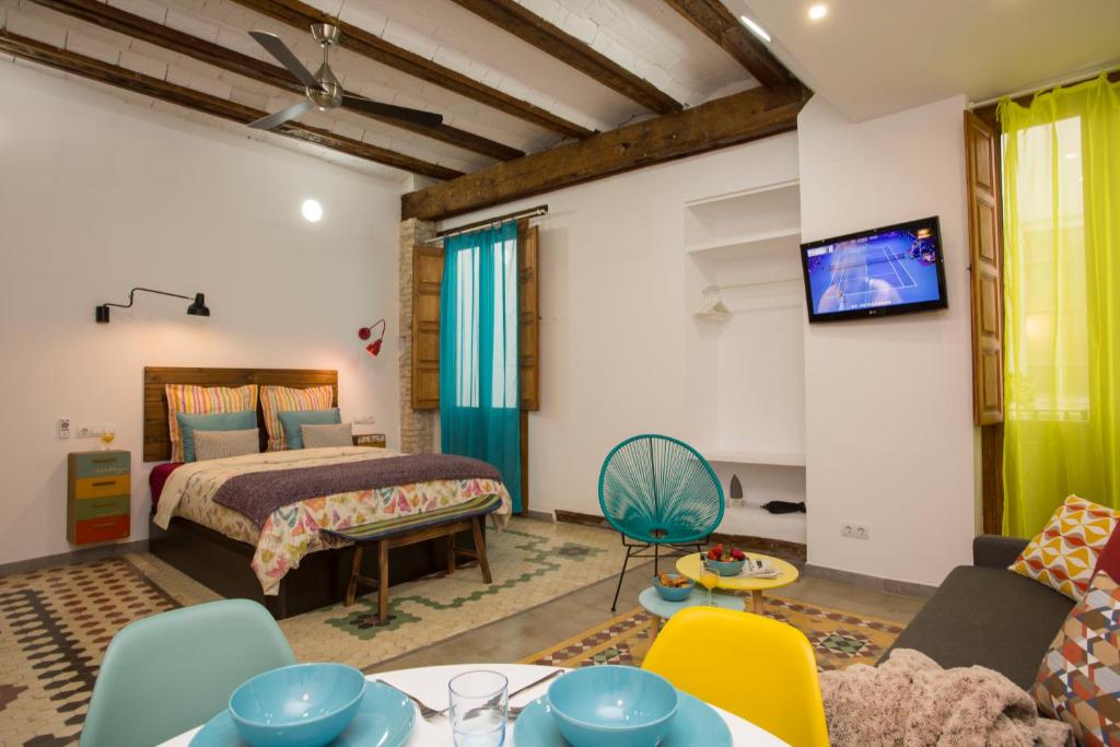 a bedroom with a bed and a living room at Eco-Friendly Apartments in Valencia