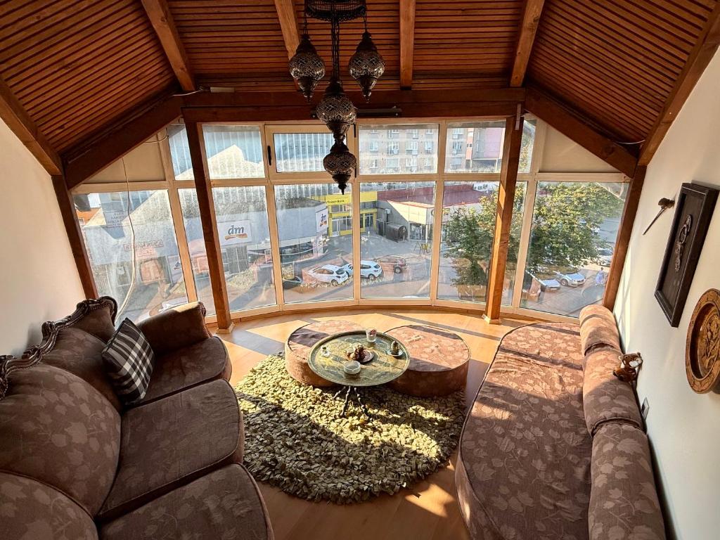 a living room with a couch and a table at Lambada Penthouse in Bugojno