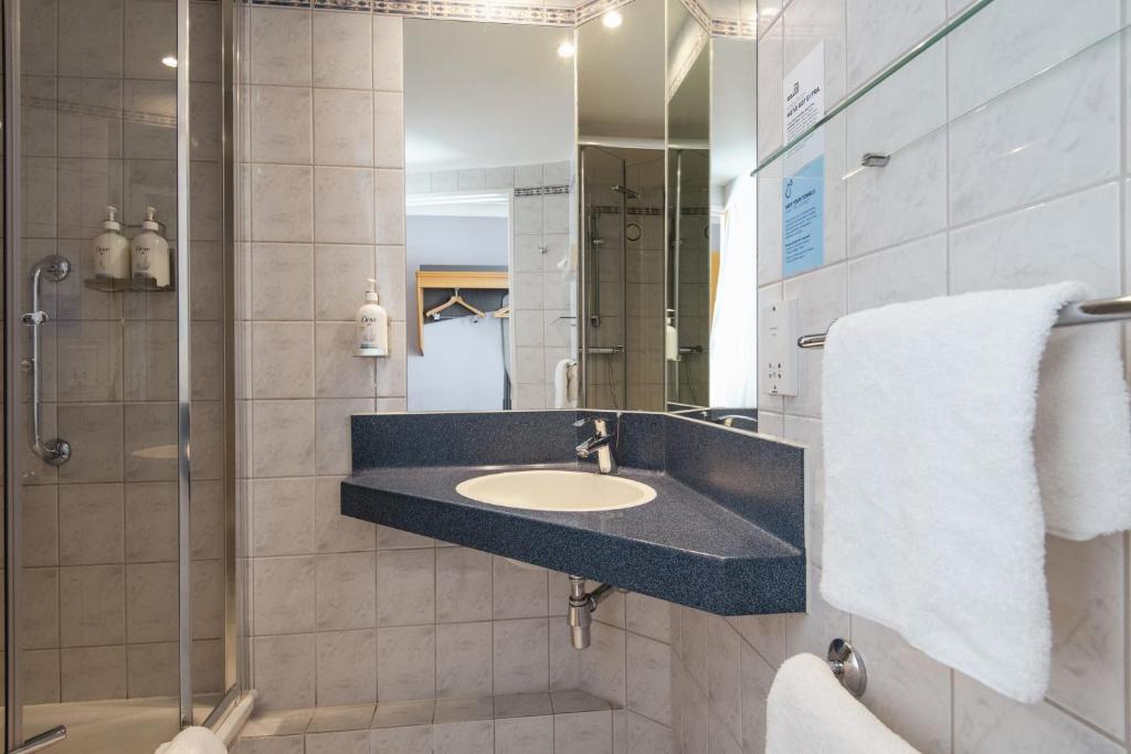a bathroom with a sink and a shower at Holiday Inn Express Stirling by IHG in Stirling