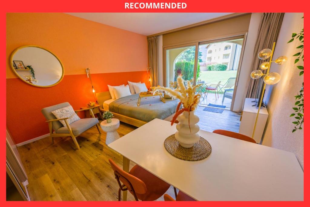 a bedroom with a bed and a table and a mirror at Spa Thermal, Design, Terrasse in Saillon