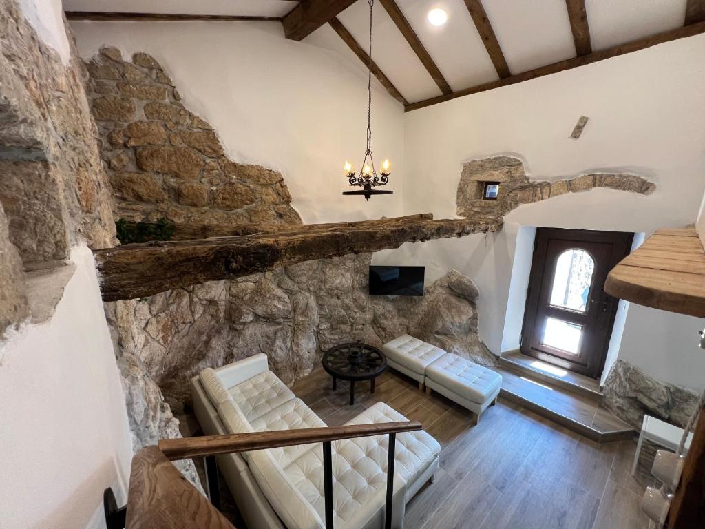 a large living room with a stone wall at Pr'Tončih in Podgorje