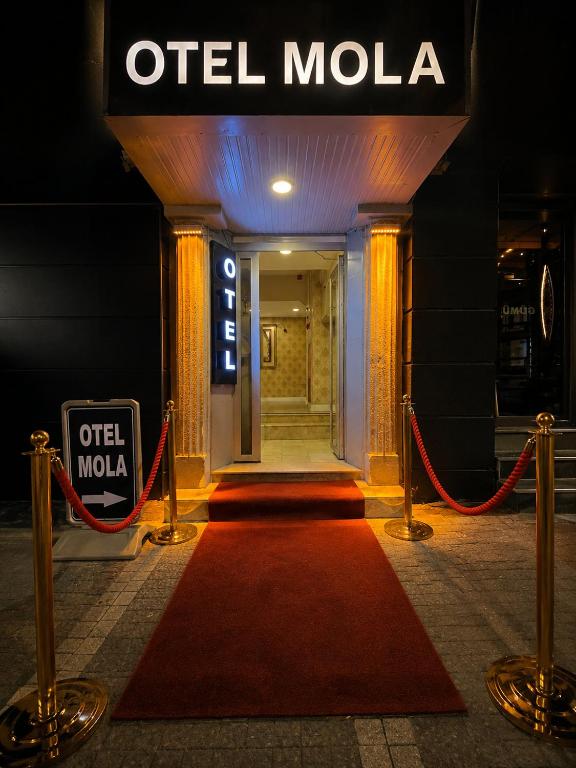 a red carpet in front of an old mola building at OTEL MOLA BALIKESiR in Balıkesir