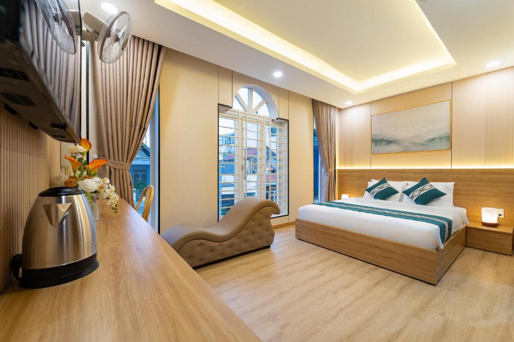 a bedroom with a bed and a desk and a window at Green Airport Hotel 2 in Ho Chi Minh City