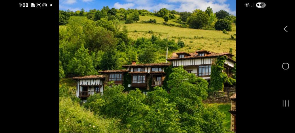 a group of houses on a hill with trees at APARTAMENTOS LA COTERA sc in Cambarco