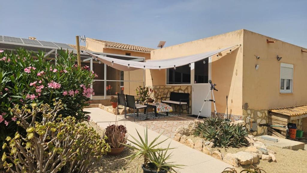 ein Haus mit einem weißen Vordach davor in der Unterkunft Finca Parella in Huércal-Overa