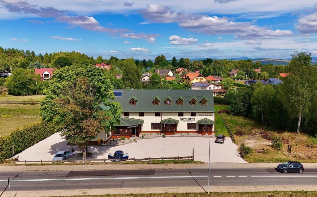 an overhead view of a large white building with a green roof at Nota Bene Pokoje Gościnne Polanica Zdrój in Polanica-Zdrój