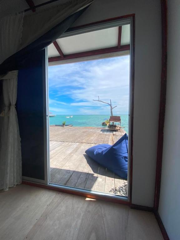 a large window with a view of the ocean at Scuba Buddy Mabul Dive Lodge in Pulau Mabul 