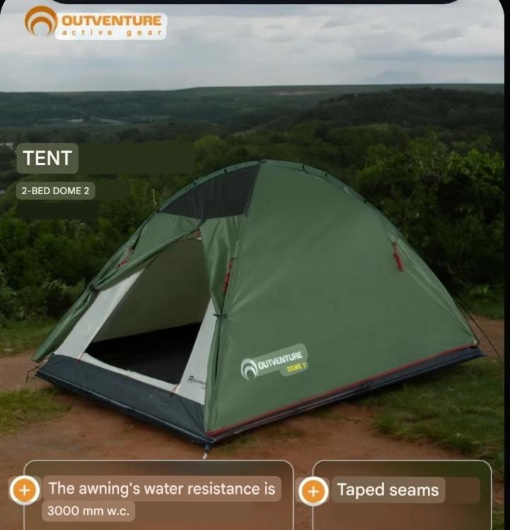 a green tent sitting on top of a field at Camping tents rent in Karakol