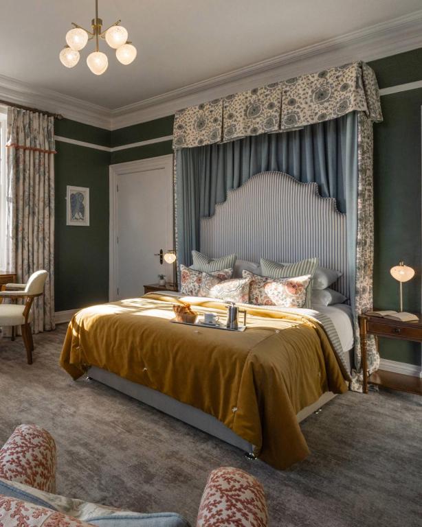 a bedroom with a large bed with a large canopy at The Harbourview Hotel in Carnlough