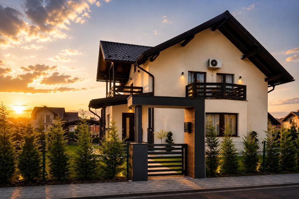 a house with the sunset in the background at Cazare Băile Figa -The Home DRM in Beclean