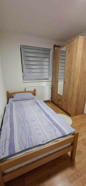 a bedroom with a bed in a room with a window at Apartman SAVKA in Gornji Ribnik