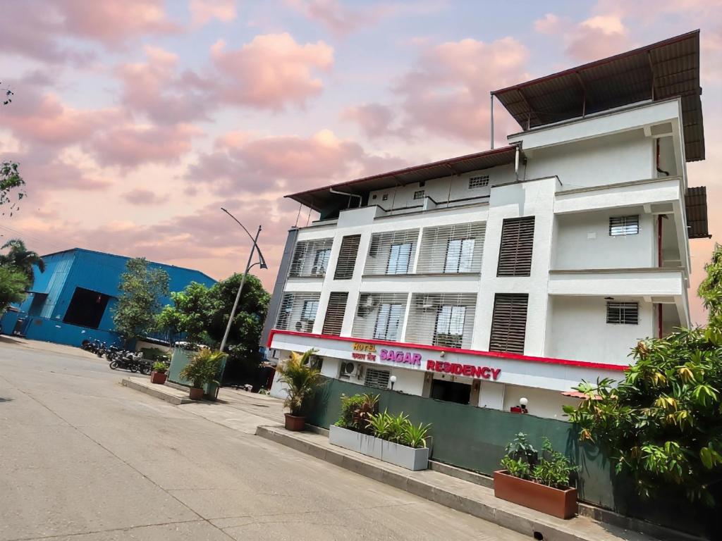 a white building on the side of a street at Hotel Sagar Residency in Panvel