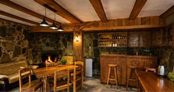 a living room with a table and a fireplace at Sunny in Mestia