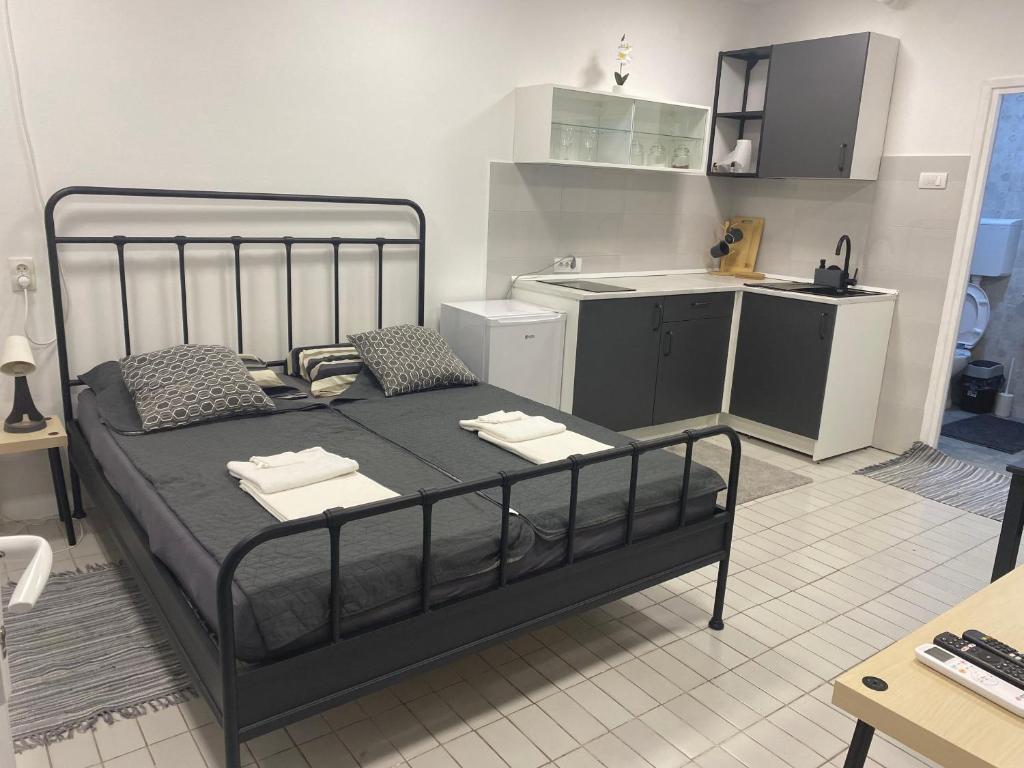 a bedroom with a bed and a small kitchen at Dona1102 in Žarkovo