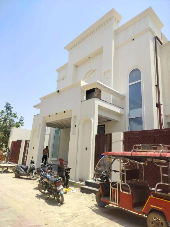 a group of motorcycles parked in front of a building at Savadhani Palace in Govardhan