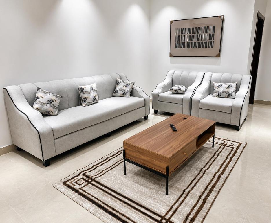 a living room with two couches and a coffee table at أرياف سويت in Al Baha
