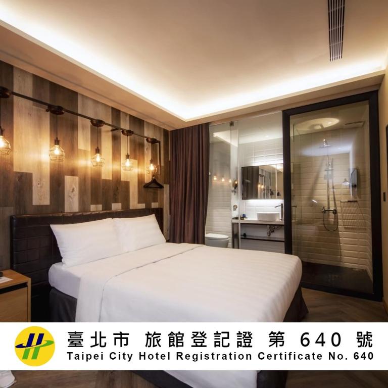 a hotel room with a white bed and a bathroom at City Suites - Beimen in Taipei