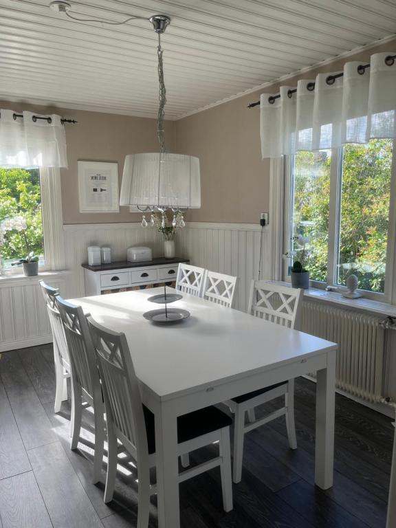 a kitchen with a white table and chairs at Villa Martini in Åmål