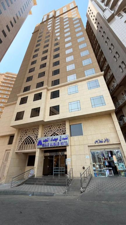 a tall building with a store in front of it at Miaad Al Majd Hotel in Mecca