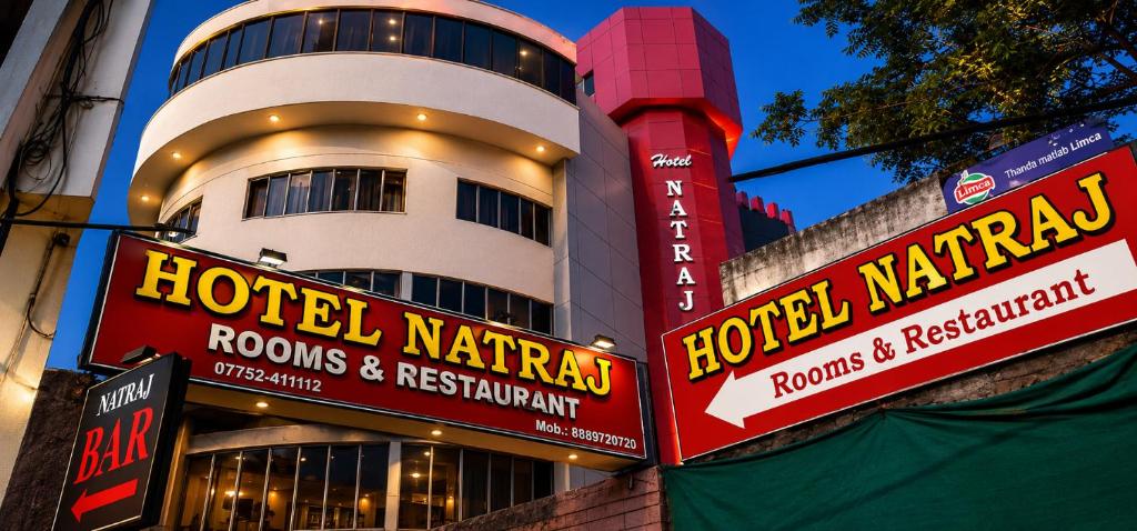 a building with signs in front of a hotel at Natraj in Bilāspur