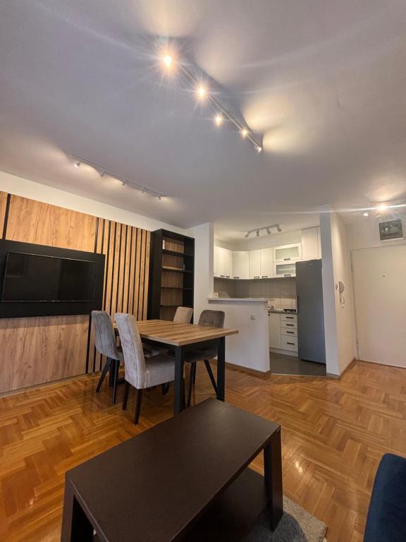 a living room with a table and a kitchen at Vanila Ub in Ub
