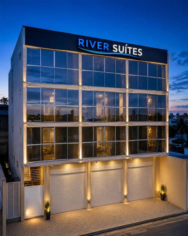 a large building with a river suites sign on it at River Suites Hotel Barreirinhas in Barreirinhas
