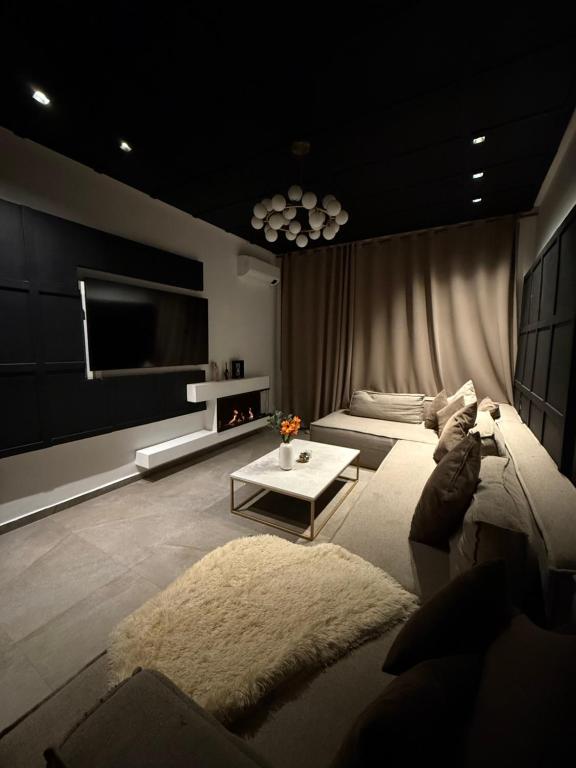 a living room with a couch and a tv at Penthouse Meknes in Meknès