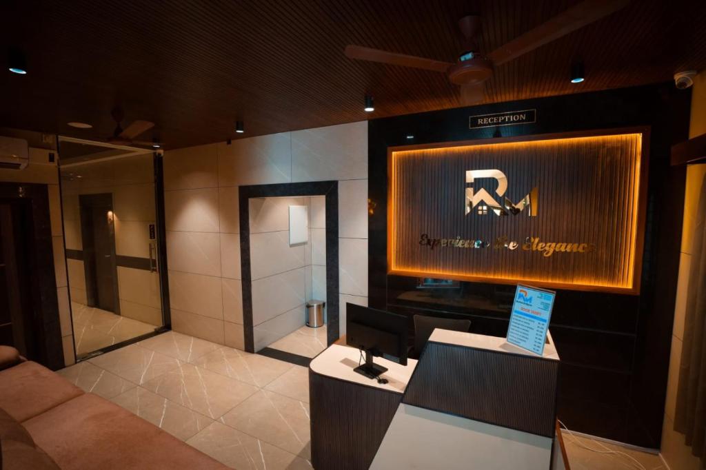 a lobby of a hotel with a sign on the wall at KAR Towers in Ārani