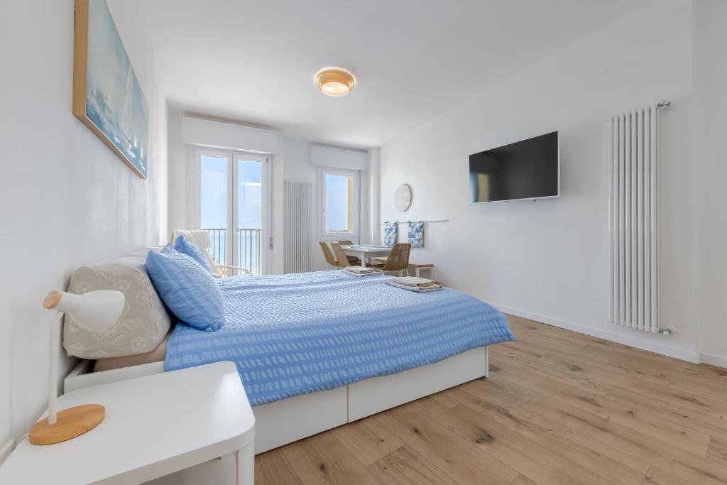 a white bedroom with a bed and a desk at HOMESTWENTY3 - Home seven - Renovated in 2026 in Caorle