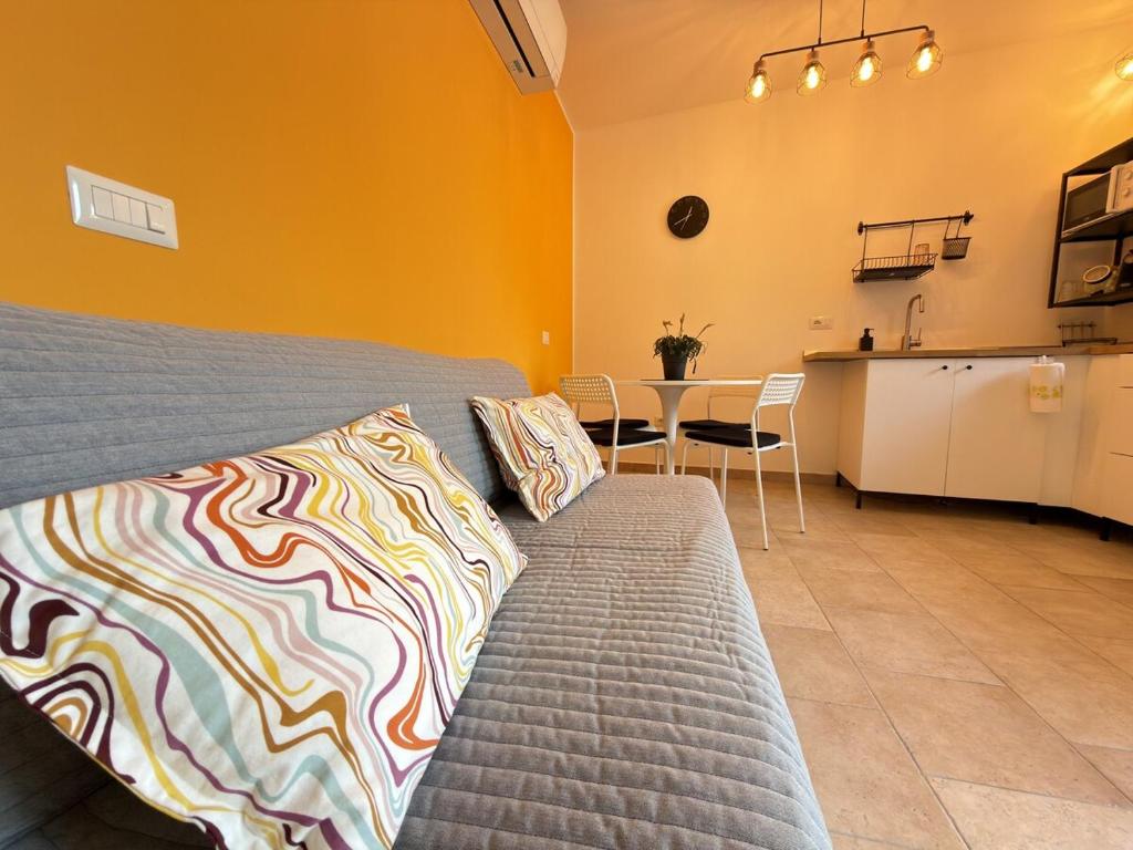 a bedroom with a bed and a kitchen with a table at Cozy House in Corte in Vimodrone