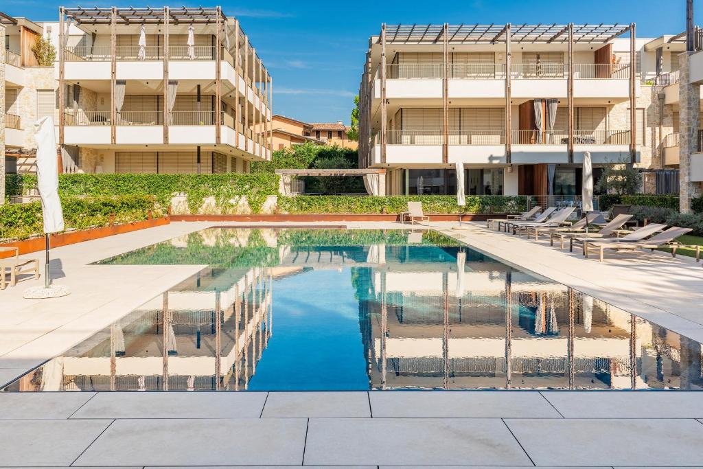 a swimming pool in front of a building at The Penthouse Bardolino in Bardolino