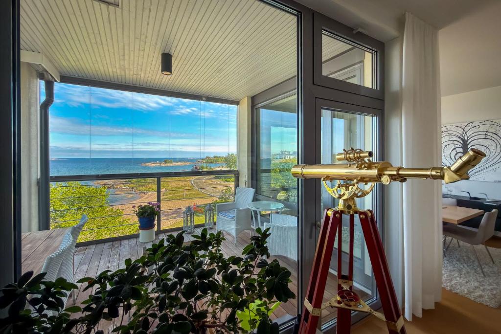 a telescope in a room with a view of the ocean at Panorama Suite in Hanko in Hanko