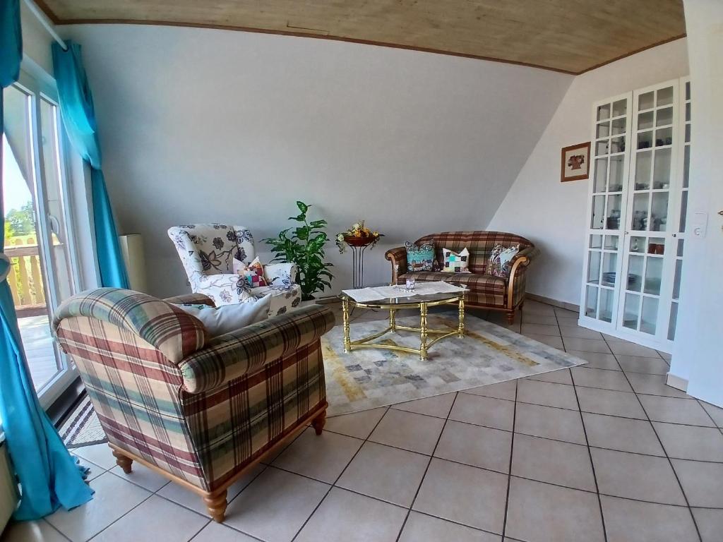 a living room with two couches and a table at Ferienwohnung Lenhardt in Barkenholm