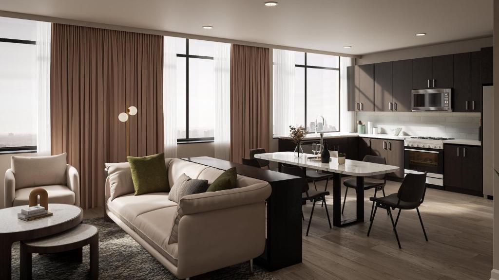 ein Wohnzimmer und eine Küche mit Sofa und Tisch in der Unterkunft Vintedge Residences in Lyndhurst