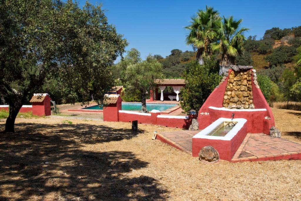 a playground with a water slide in a park at Villa Rural Las Encinas in Alosno