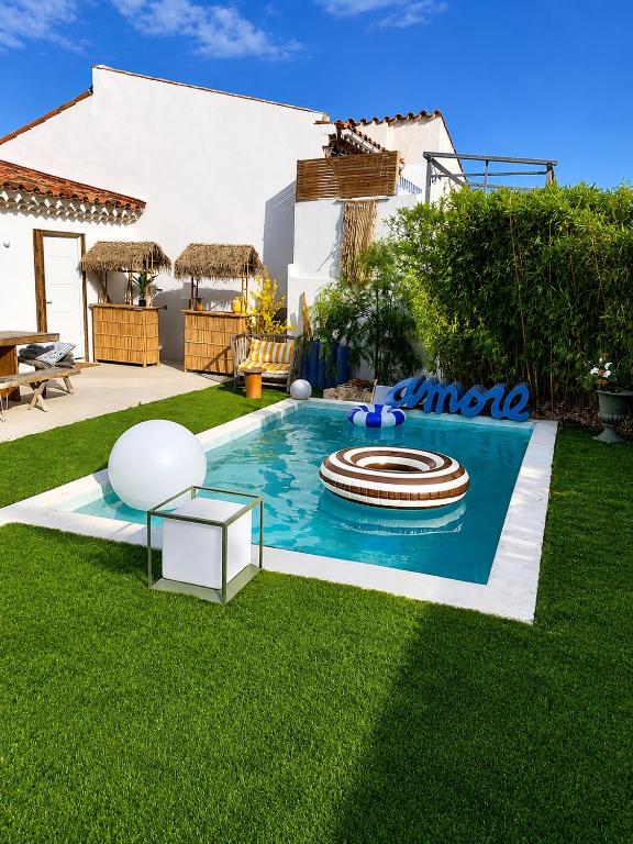 a swimming pool with a pool noodle in a yard at Villa Boho Cassis in Cassis