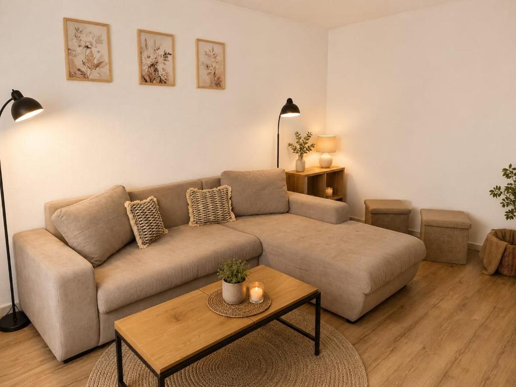 a living room with a couch and a coffee table at Hanga Apartman in Băile Tuşnad