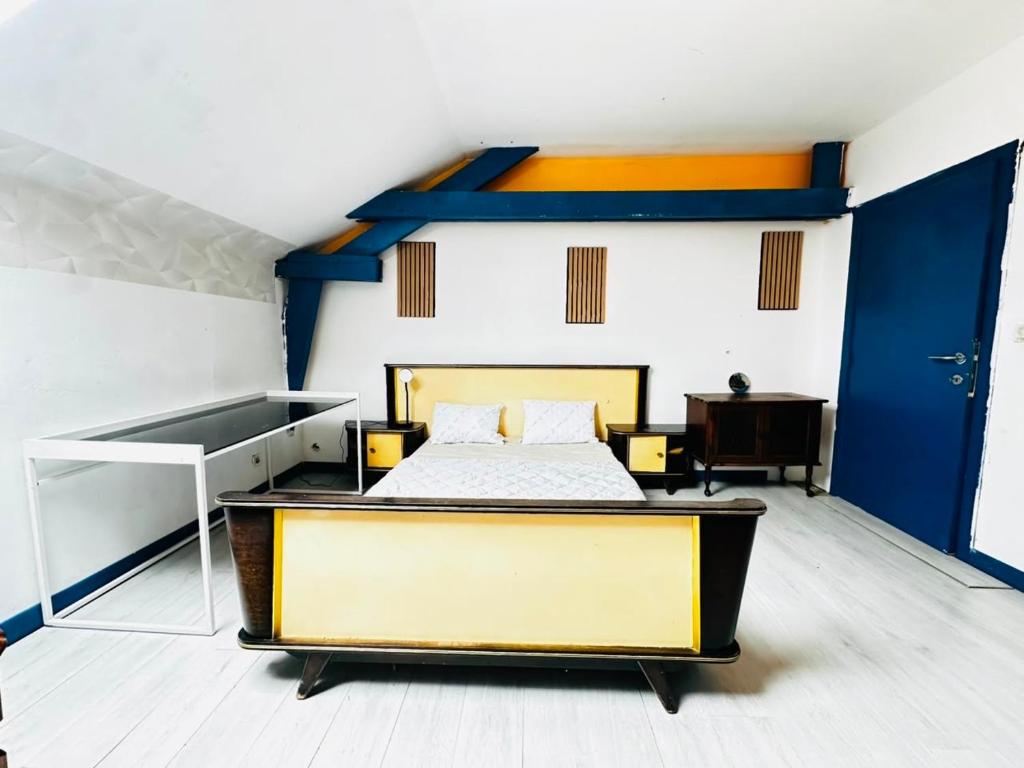 a bedroom with a bed and a blue and white wall at Echappée Rétro in Frameries