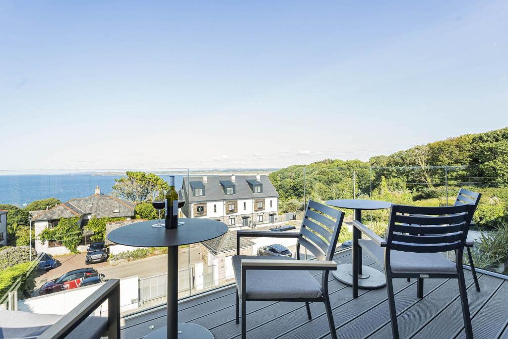 a patio with two chairs and a table on a balcony at 8 Salt in St Ives
