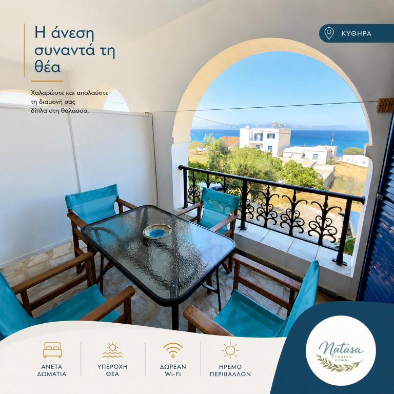 a balcony with a table and chairs and a view of the ocean at Natasa studios Kythera in Kythira