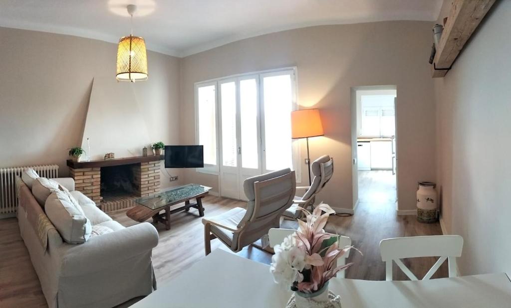 a living room with a couch and a table at Cal NEN PAU in Sant Boi de Lluçanès