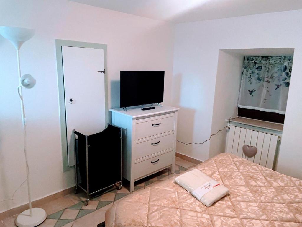 a bedroom with a bed and a television on a dresser at Mission Holiday in Penna in Teverina