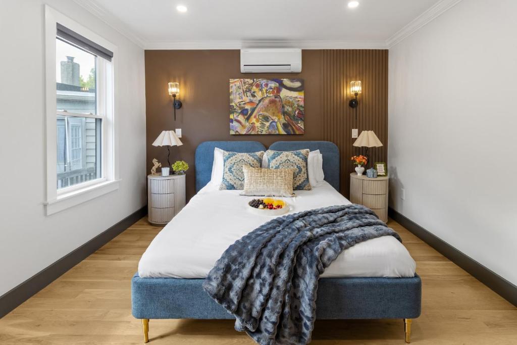 a bedroom with a large bed with a blue headboard at Harvard Charm Near Boston New build in Cambridge