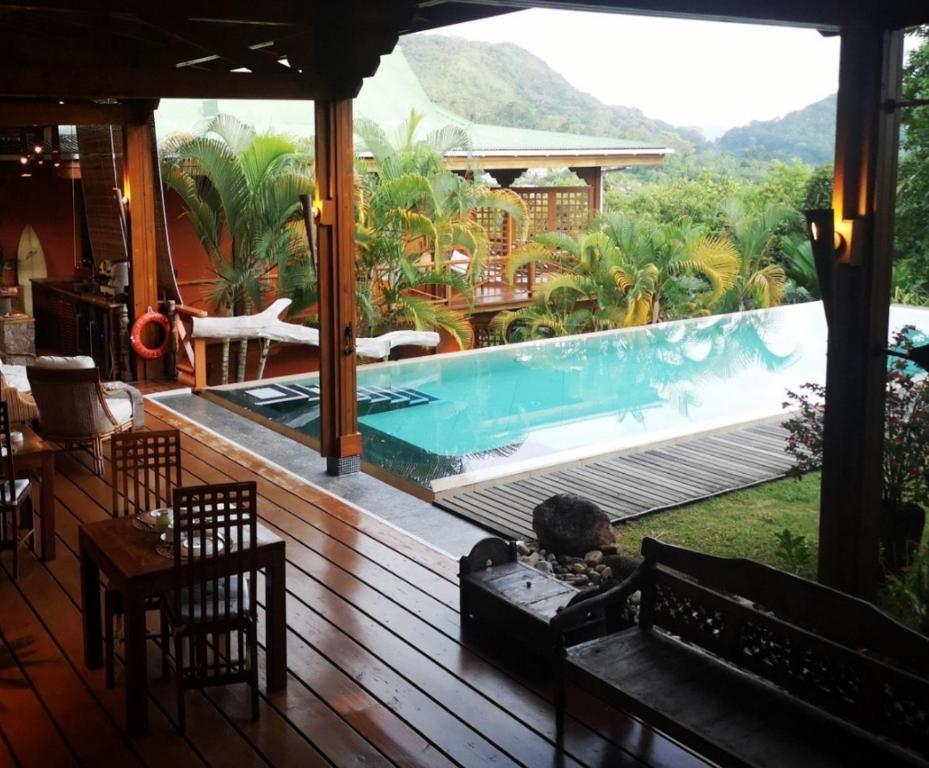 a deck with a swimming pool on a house at Villa Vanilla in Port Glaud