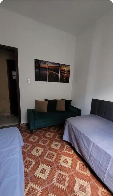 a living room with two beds and a couch at Entire house in Mococa