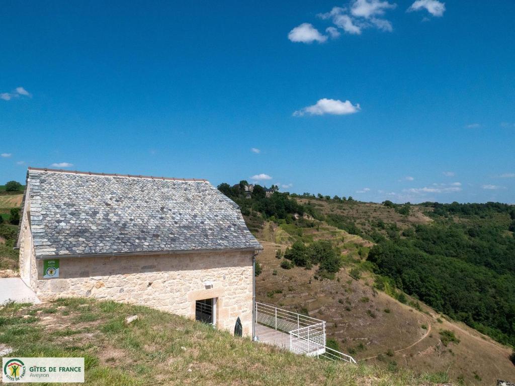 an old stone building on a hill with trees at Ma Cabane in Mouret