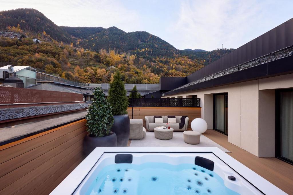 a hot tub on the roof of a building at MiM Andorra member of Meliá Collection in Escaldes-Engordany