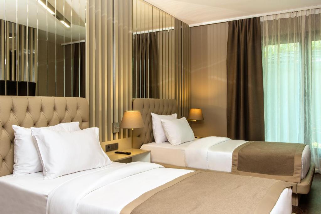 a hotel room with two beds and a window at Hann Hotel in Istanbul