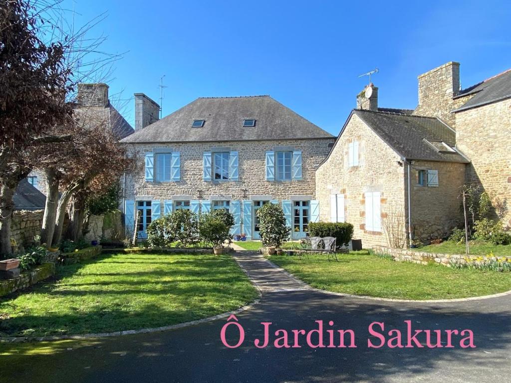 a large brick house with a driveway at O Jardin Sakura Chambres et table d'hotes sur la route du Mont Saint-Michel in Val Couesnon