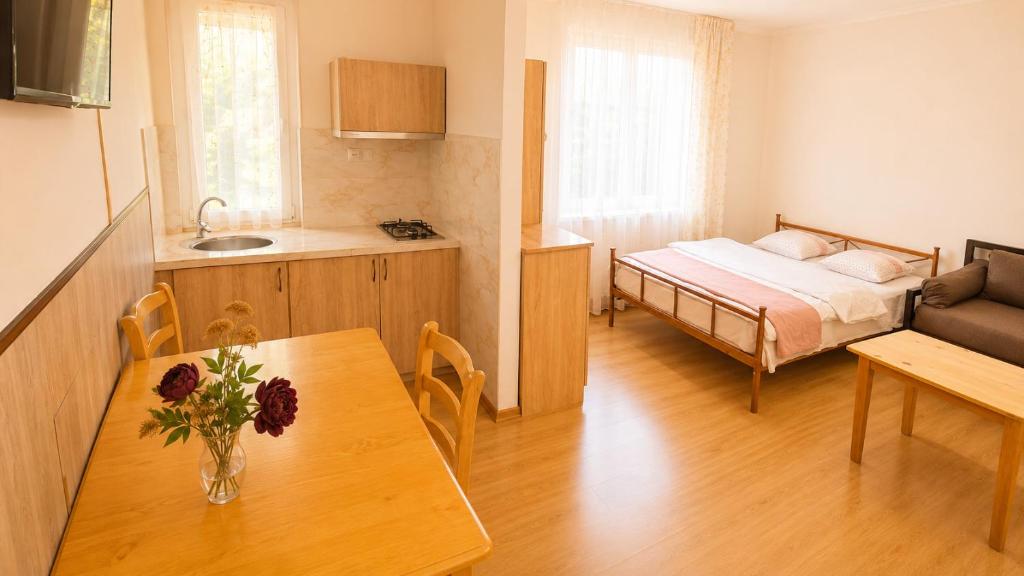 a small room with a bed and a dining table at Tuz House R2 in Bakuriani